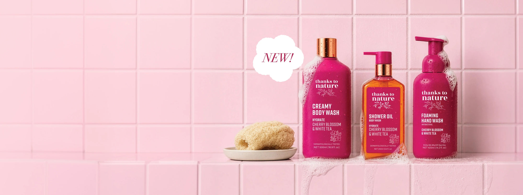 Three bottles of 'Thanks to Nature' Cherry Blossom Range body wash on a pink tiled background