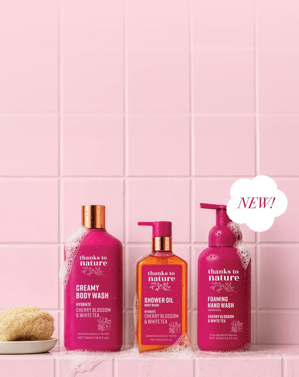 3 bottles of Thanks to Nature Cherry Blossom Range on a pink tile background