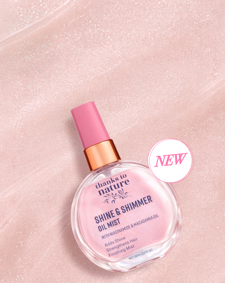 Shine & Shimmer oil mist bottle with pink spray nozzle on a pink background