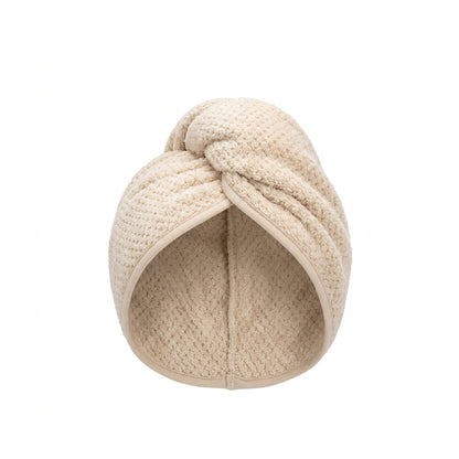 Beige knitted headband on a white background