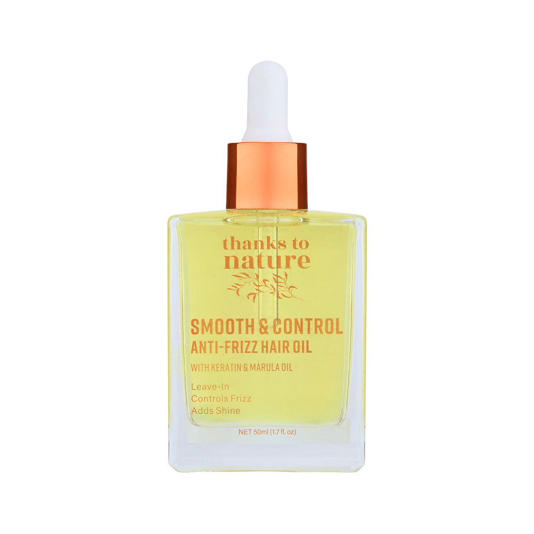 Bottle of 'thanks to nature' smooth & control anti-frizz hair oil with a dropper on a white background