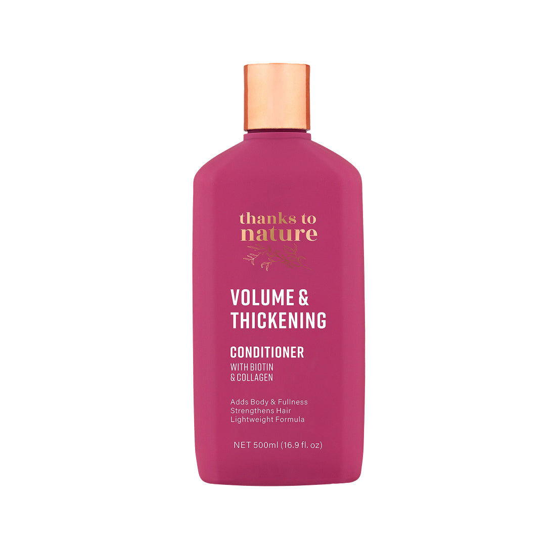 A 500ml bottle of Thanks to Nature Volume & Thickening Conditioner. The bottle is a vibrant magenta pink with a metallic copper cap, featuring gold and white text on the front, set against a plain white background.