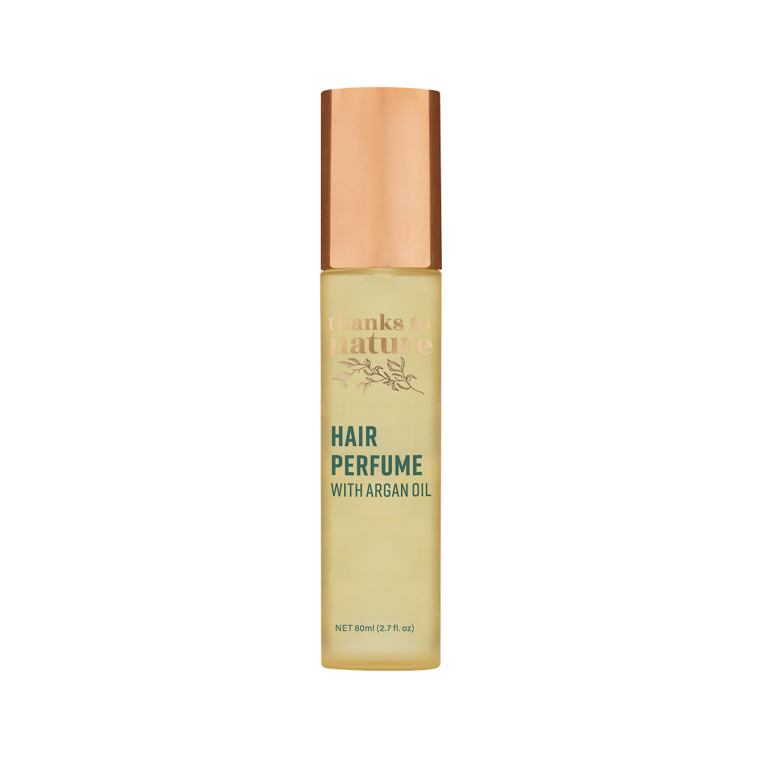 Hair perfume bottle with argan oil on a white background