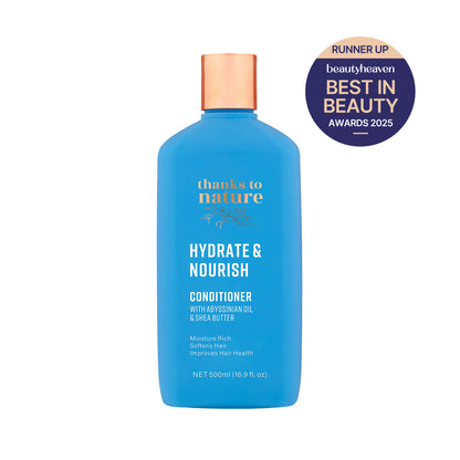 Blue conditioner bottle with 'thanks to nature' branding and a Best in Beauty Award badge on a white background.