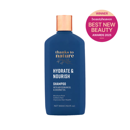 Blue shampoo bottle with bronze cap labeled 'thanks to nature Hydrate & Nourish' on a white background.