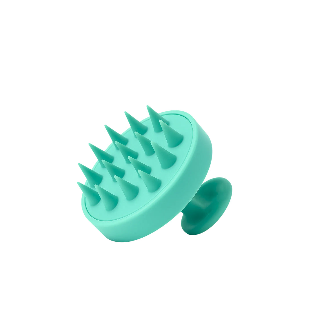 Turquoise silicone grooming tool with spike-like projections on a white background